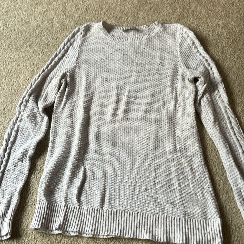 Long sleeved white with small red and blue flecks sweater.